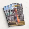Pile of closed custom softcover comics with colorful artwork